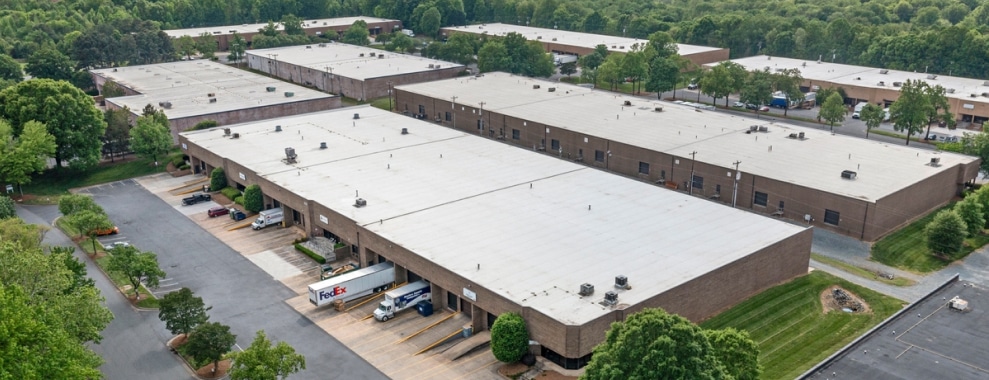 Aerial view of a large complex with multiple long rectangular buildings with flat roofs