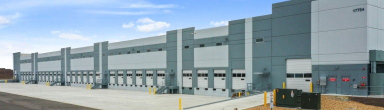 A large rectangular building with multiple loading dock doors