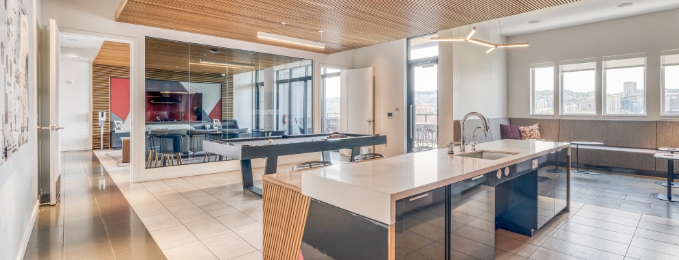 A modern kitchen area with a long countertop