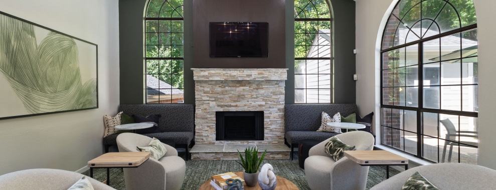 A living room with a modern design, a fireplace with stone facade in the center