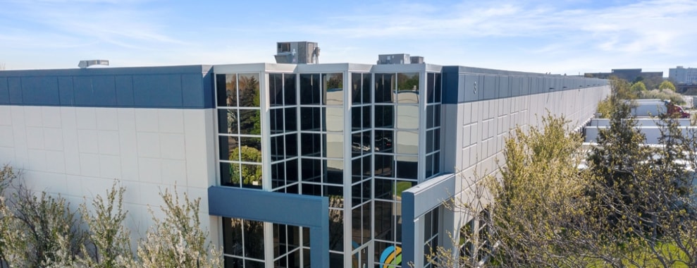 The exterior of a modern, mid-rise glass-fronted building