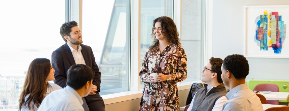 Three people in a room with large windows